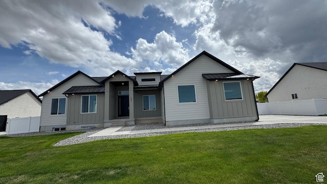 view of front facade with board and batten siding, a standing seam roof, and metal roof