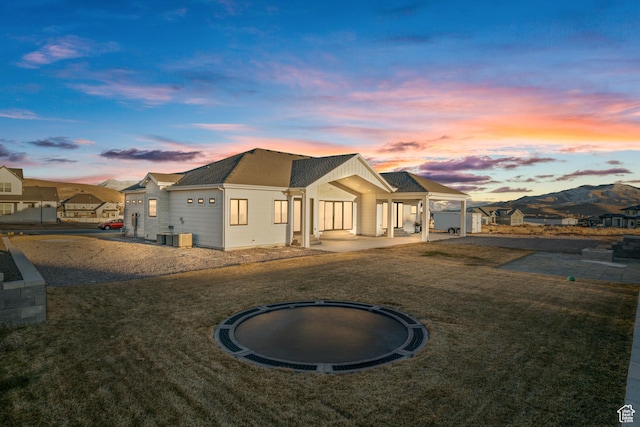 9749 N Hibiscus Ln, Eagle Mountain, UT 84005 - modern inspired farmhouse featuring a front lawn and a patio area
