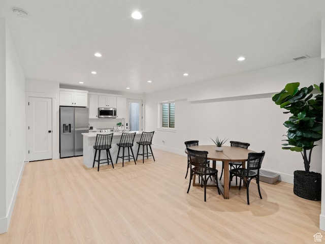 9749 N Hibiscus Ln, Eagle Mountain, UT 84005 - dining space featuring light wood-type flooring, baseboards, and recessed lighting