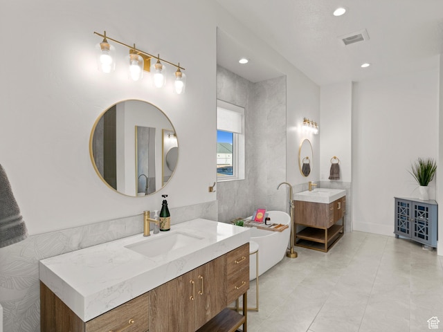 9749 N Hibiscus Ln, Eagle Mountain, UT 84005 - full bathroom featuring two vanities, a soaking tub, and recessed lighting