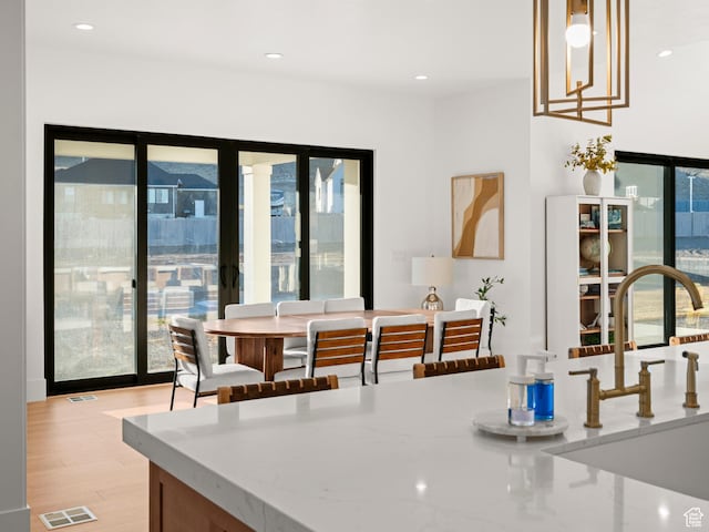 9749 N Hibiscus Ln, Eagle Mountain, UT 84005 - dining space with healthy amount of natural light, light wood finished floors, and recessed lighting