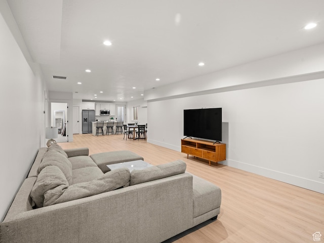 9749 N Hibiscus Ln, Eagle Mountain, UT 84005 - living area featuring recessed lighting, light wood finished floors, and baseboards
