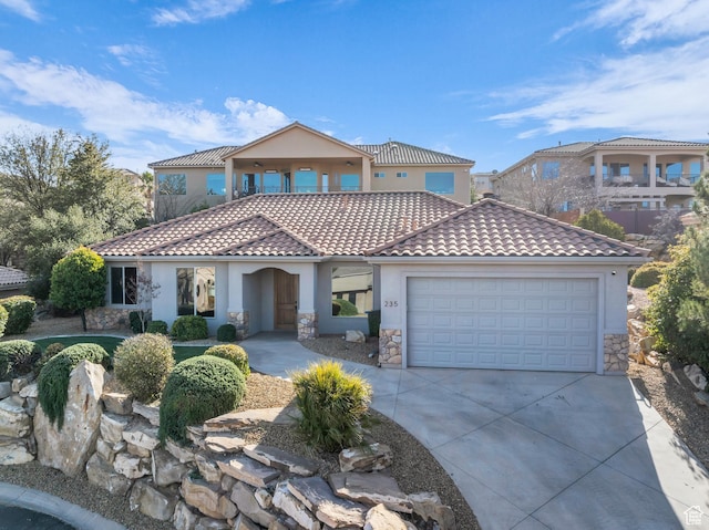 mediterranean / spanish-style home with a garage