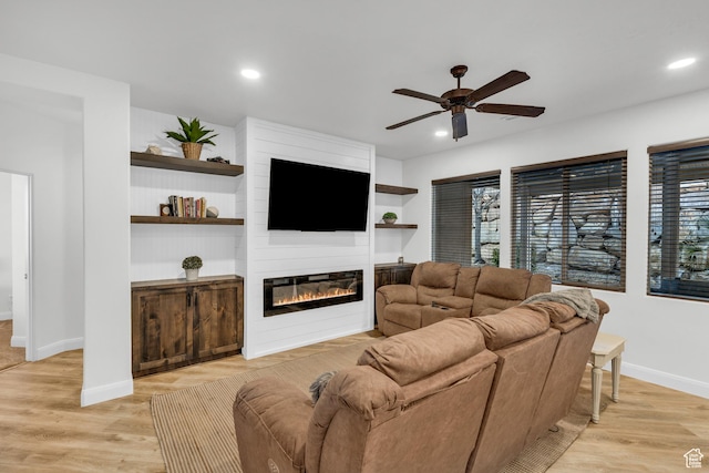 235 W Golden Eagle Cir, St George, UT 84770 - living room featuring ceiling fan, a fireplace, light hardwood / wood-style floors, and built in shelves