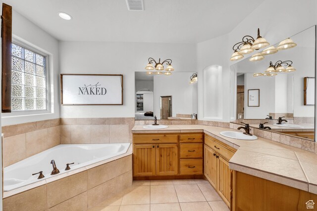 235 W Golden Eagle Cir, St George, UT 84770 - bathroom with tile patterned flooring, vanity, and tiled tub