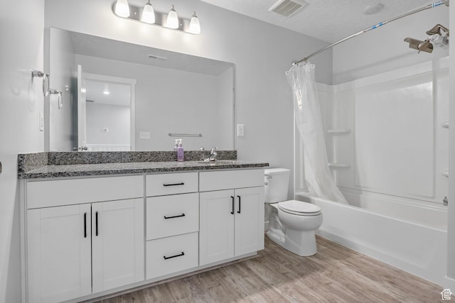 4421 W 150 N, West Point, UT 84015 - full bathroom featuring hardwood / wood-style floors, vanity, shower / tub combo, toilet, and a textured ceiling