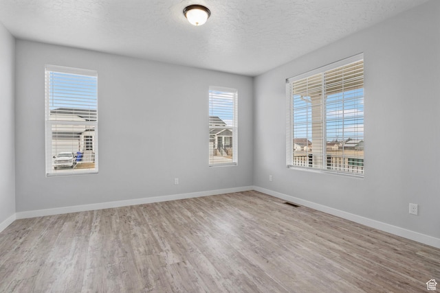 4421 W 150 N, West Point, UT 84015 - empty room with a textured ceiling and light hardwood / wood-style flooring