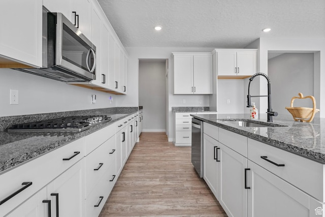 4421 W 150 N, West Point, UT 84015 - kitchen featuring stainless steel appliances, white cabinetry, sink, and a textured ceiling