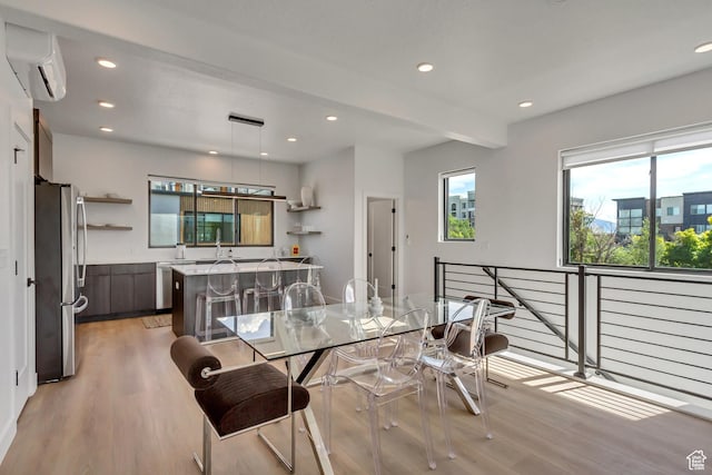 dining room with a wall mounted AC, light wood-type flooring, and recessed lighting
