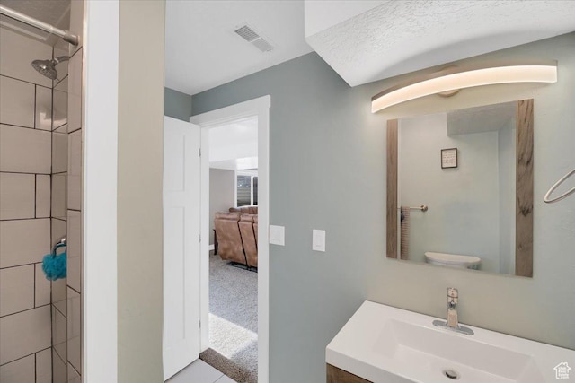 820 S 525 E, River Heights, UT 84321 - bathroom with visible vents, a tile shower, and vanity