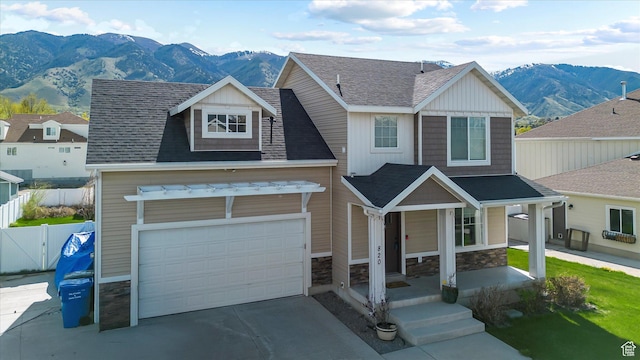 820 S 525 E, River Heights, UT 84321 - craftsman house featuring fence, covered porch, stone siding, a mountain view, and driveway