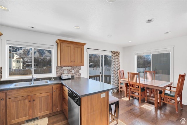 820 S 525 E, River Heights, UT 84321 - kitchen with stainless steel dishwasher, a peninsula, hardwood / wood-style floors, a breakfast bar area, and a sink