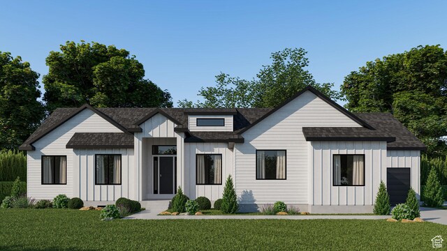 modern farmhouse style home featuring board and batten siding, a shingled roof, and a front yard