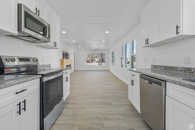 448 N 900 W, Salt Lake City, UT 84116 - kitchen with recessed lighting, white cabinetry, light wood-style floors, appliances with stainless steel finishes, and light stone countertops