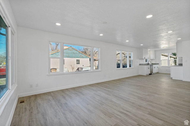 448 N 900 W, Salt Lake City, UT 84116 - unfurnished living room with light wood-style floors, baseboards, visible vents, and recessed lighting