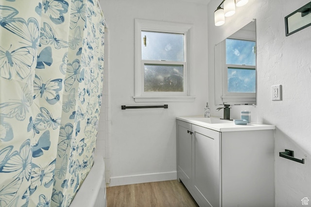 448 N 900 W, Salt Lake City, UT 84116 - full bathroom featuring shower / bath combo with shower curtain, wood finished floors, vanity, and baseboards