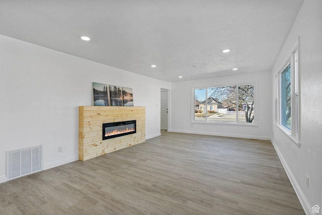 448 N 900 W, Salt Lake City, UT 84116 - unfurnished living room featuring recessed lighting, visible vents, a glass covered fireplace, wood finished floors, and baseboards