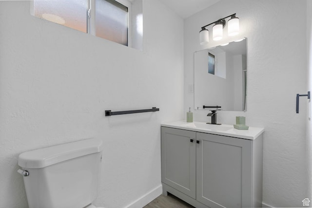 448 N 900 W, Salt Lake City, UT 84116 - bathroom featuring toilet, baseboards, wood finished floors, and vanity