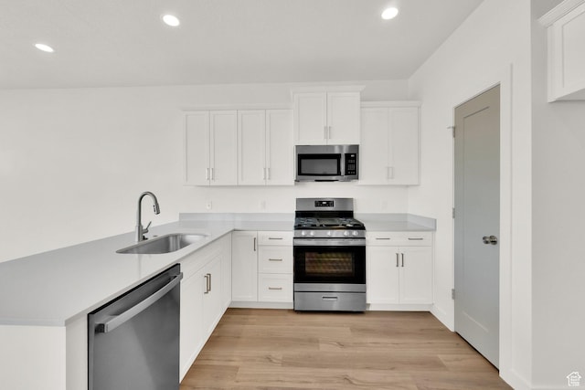 103 E 1760 N, Heber City, UT 84032 - kitchen with appliances with stainless steel finishes, light hardwood / wood-style floors, sink, and white cabinets