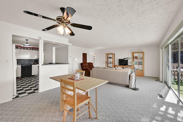 carpeted dining room featuring a textured ceiling and a ceiling fan