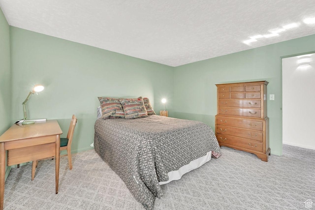 carpeted bedroom with baseboards and a textured ceiling