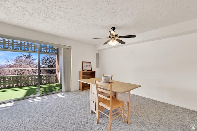 office area with a textured ceiling, carpet flooring, ceiling fan, and baseboards