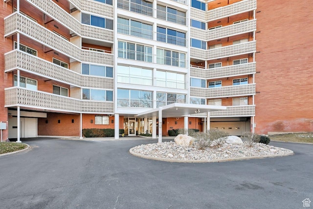 view of apartment building / complex featuring asphalt driveway