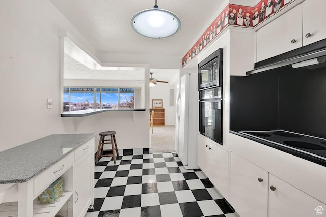 kitchen featuring black appliances, dark floors, white cabinetry, open shelves, and a ceiling fan