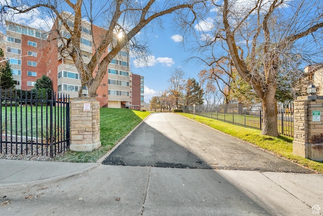 view of asphalt street featuring curbs