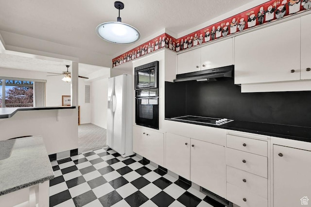 kitchen with black appliances, under cabinet range hood, tile patterned floors, white cabinets, and a ceiling fan