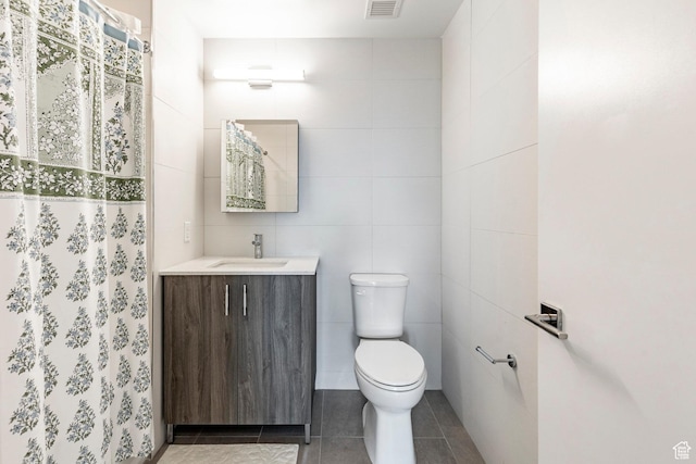 2303 Deer Hollow Rd Unit 1329, Park City, UT 84060 - bathroom featuring vanity, toilet, tile patterned flooring, and tile walls