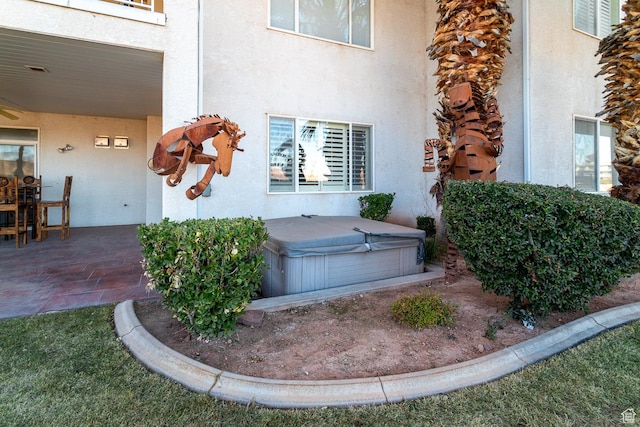 exterior space featuring a hot tub and a patio
