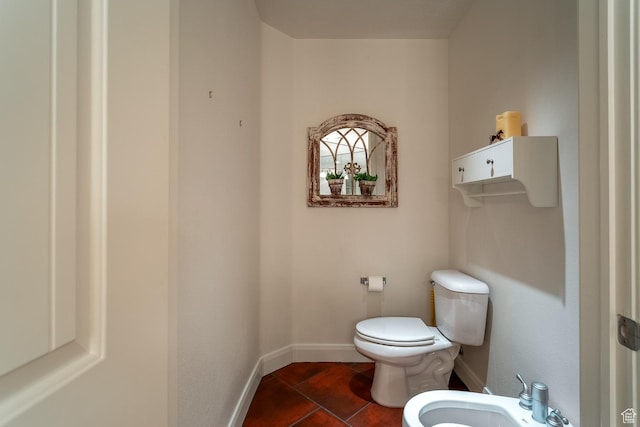 bathroom featuring a bidet, tile patterned floors, and toilet