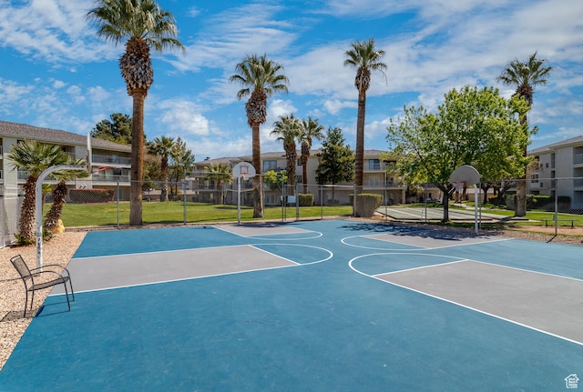 view of sport court featuring a lawn