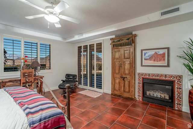 bedroom with ceiling fan, a high end fireplace, and access to outside