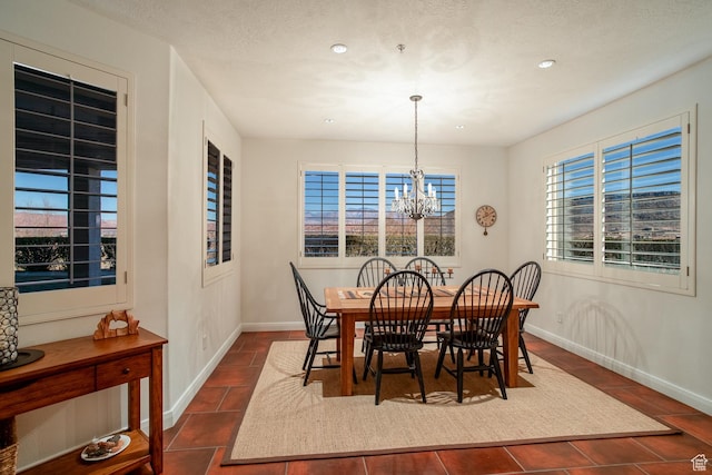 dining room with an inviting chandelier and dark tile patterned floors