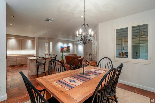 dining space featuring a notable chandelier