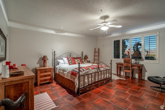 bedroom with a textured ceiling and ceiling fan