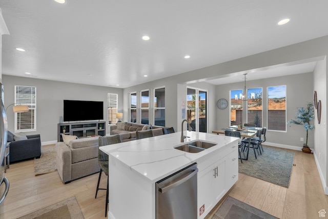 1439 N Arena Roja Dr, Washington, UT 84780 - kitchen with sink, light hardwood / wood-style floors, an island with sink, white cabinets, and stainless steel dishwasher
