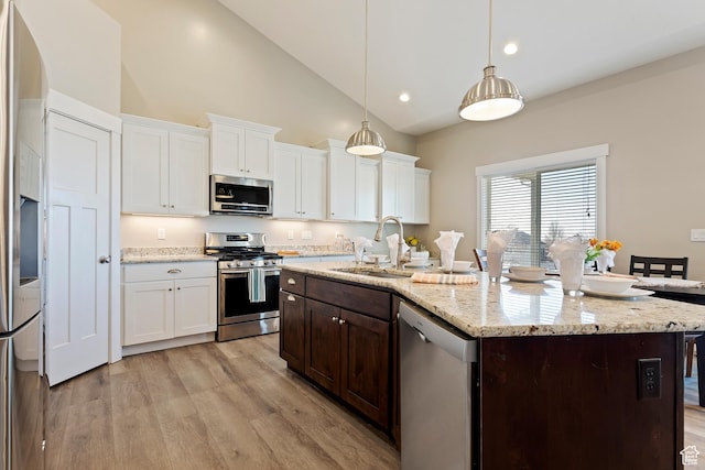 1407 N Mountain Rd, Ogden, UT 84404 - kitchen with stainless steel appliances, decorative light fixtures, a center island with sink, and white cabinets