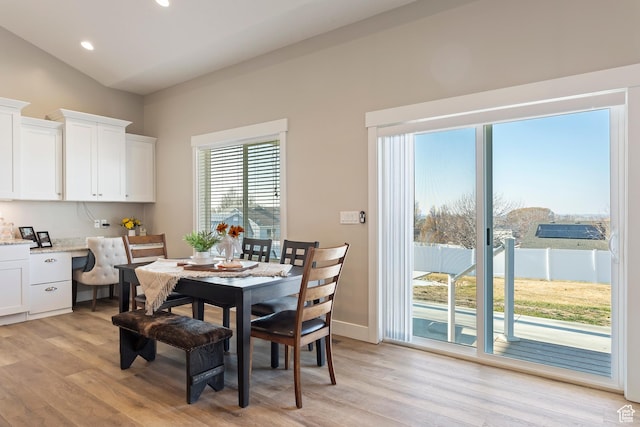 1407 N Mountain Rd, Ogden, UT 84404 - dining area featuring vaulted ceiling, built in desk, and light hardwood / wood-style floors