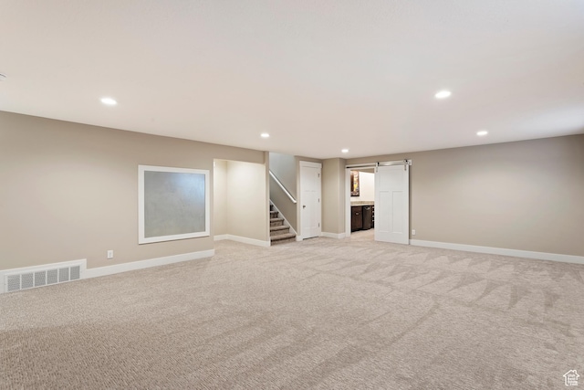 1407 N Mountain Rd, Ogden, UT 84404 - basement with light carpet and a barn door