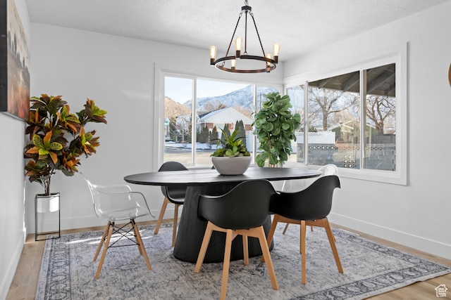 2386 E Lakeview Dr S, Millcreek, UT 84109 - dining area featuring a mountain view, light hardwood / wood-style floors, and a notable chandelier