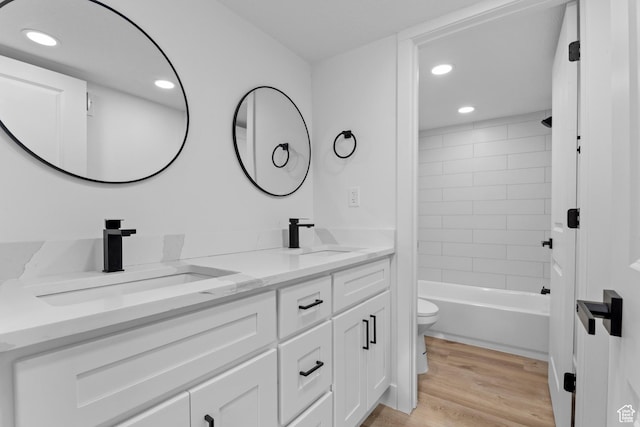 2386 E Lakeview Dr S, Millcreek, UT 84109 - full bathroom with hardwood / wood-style flooring, tiled shower / bath, vanity, and toilet