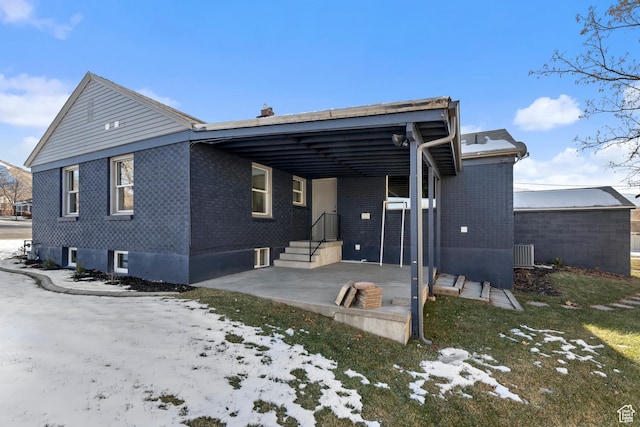 2386 E Lakeview Dr S, Millcreek, UT 84109 - snow covered back of property featuring central AC and a patio