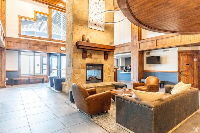 2669 Canyons Resort Dr Unit 101, Park City, UT 84098 - living room with light tile patterned floors, wooden walls, high vaulted ceiling, a stone fireplace, and wooden ceiling