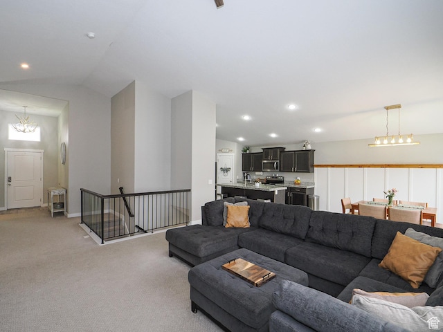 living room featuring baseboards, light colored carpet, lofted ceiling, recessed lighting, and an inviting chandelier