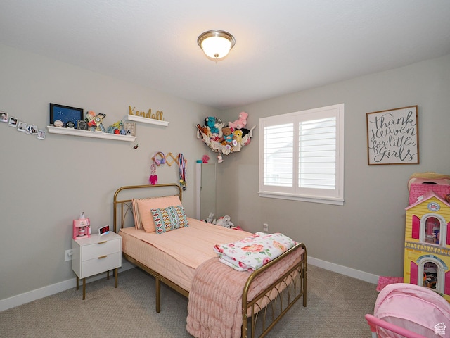 bedroom featuring baseboards and carpet floors