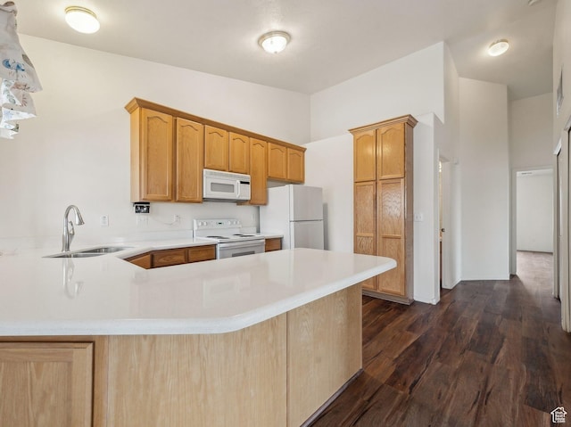 3859 S Mitchell Cv E Unit 203, South Salt Lake, UT 84115 - kitchen featuring sink, white appliances, dark hardwood / wood-style floors, and kitchen peninsula