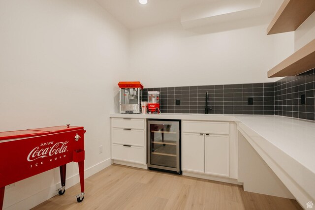 994 W Union Bench Dr S, Mapleton, UT 84664 - kitchen with beverage cooler, backsplash, a sink, and light wood-style flooring